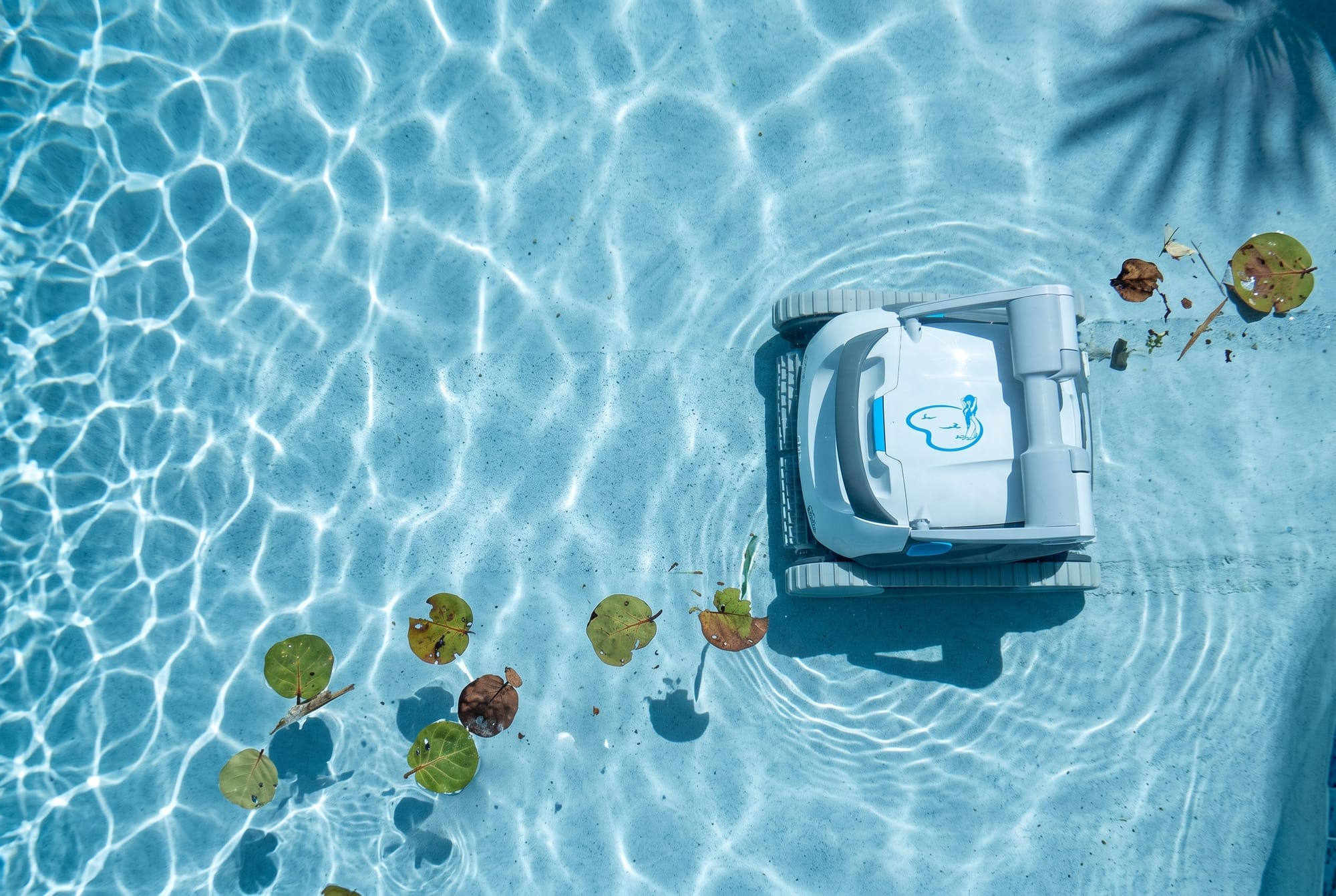 Robotic pool cleaner working across the floor of a Miami swimming pool