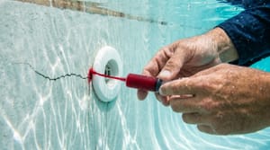 Pool leak detection dye test near return fitting in Miami residential pool