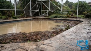 Miami backyard pool full of cloudy brown floodwater and debris after a storm