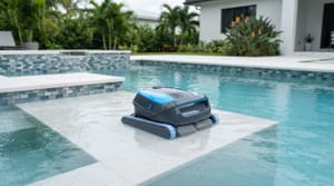 Robotic pool cleaner on the step of a clear Miami backyard swimming pool