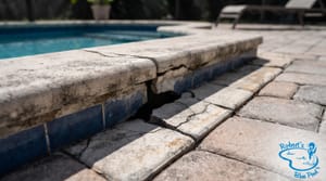 Cracked pool expansion joints showing thermal damage in Miami summer heat